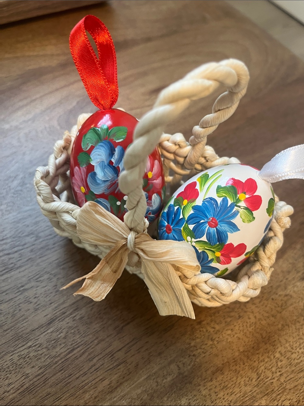 Painted wooden eggs in a basket